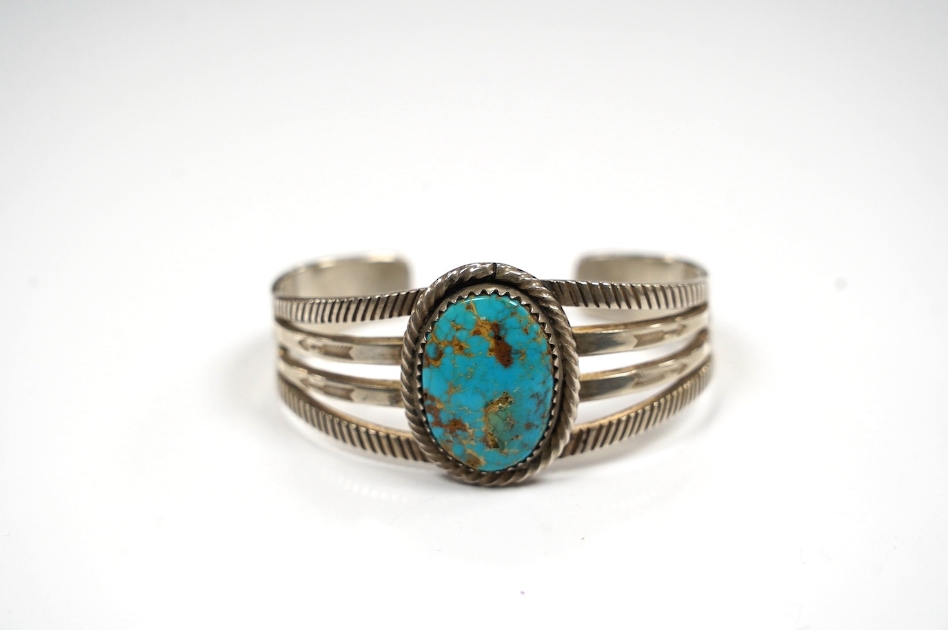 A Navaho? turquoise set white metal open bangle. Condition - fair